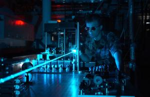 An airman conducts a laser experiment.