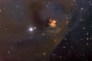 The T Tauri system NGC 1555, sometimes known as Hind's Variable Nebula.