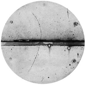 Photograph of a cloud chamber showing the first discovered positron.