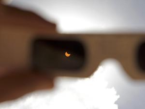 The view through eclipse glasses during a partial eclipse.