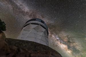 The sparkling band of the Milky Way Galaxy backdrops the Nicholas U. Mayall 4-meter Telescope, located at Kitt Peak National Observatory.