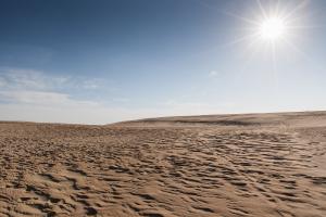 A desert sky and sand dunes.