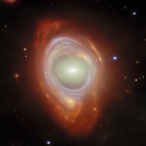 A spiral galaxy lensed around a closer elliptical galaxy.