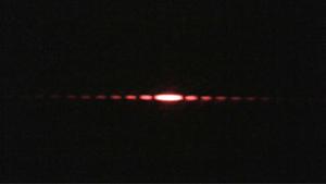Image of the diffraction pattern created by a laser passing through a double slit.