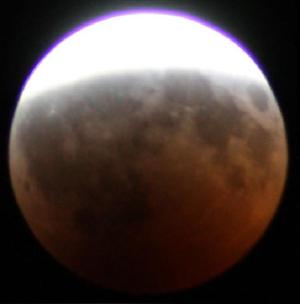 The round shadow of Earth against the Moon.