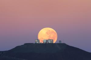 The Moon appears to loom over ESO’s Very Large Telescope.