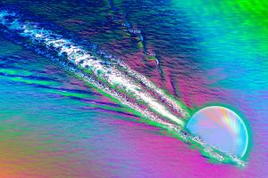 In this illustration a quark zooms through quark-gluon plasma, creating a wake in the plasma.