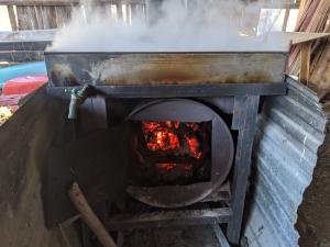 The wood-fired cooker needs to be tended for hours on end.